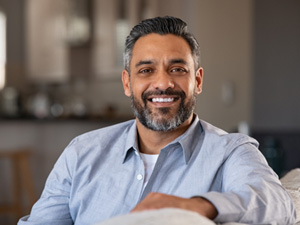 Man smiling while sitting in couch at home