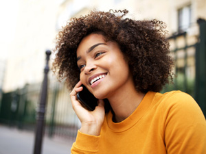 Woman smiling while talking on phone