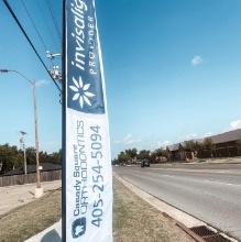 Flag for Casady Square Orthodontics on side of road
