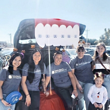 Oklahoma City orthodontic team smiling by car with open trunk