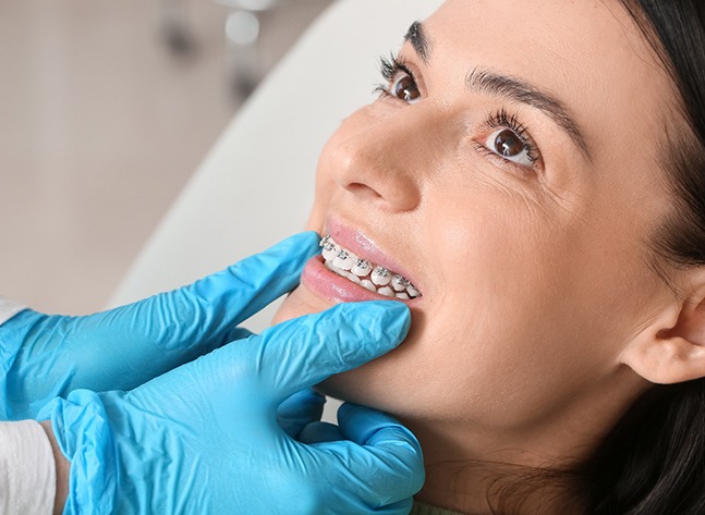 A woman being treated for an orthodontic emergency by an orthodontist