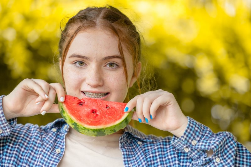 Patient with braces eating watermelon.