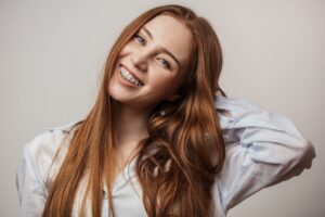 Young woman with braces smiling